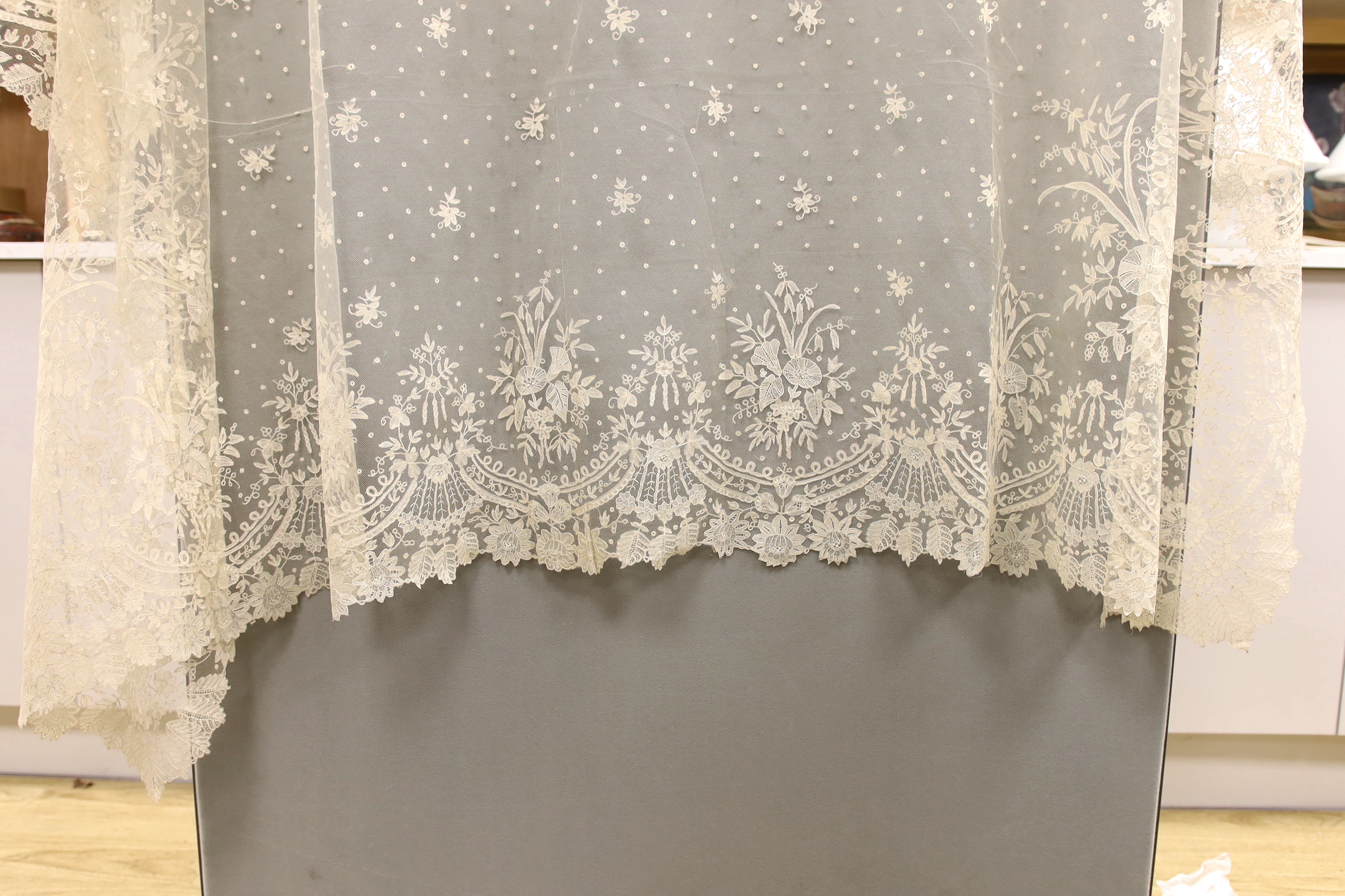 A 19th century Brussels bobbin lace wedding veil with point de gaze needle lace border and insertions, 196cm x 192cm